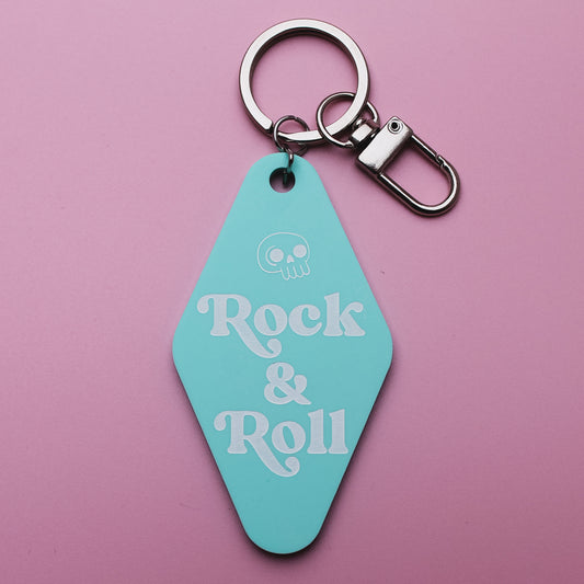 Turquoise Motel style keychain with 'Rock & Roll' text on a pink background
