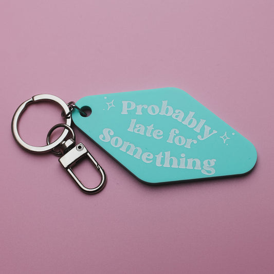 Teal motel style keyring tag with 'Probably late for something' text on a pink background