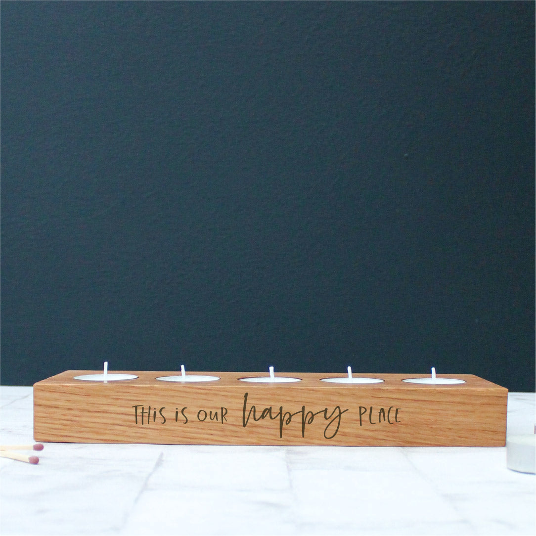 chunky wooden solid oak tealight holder engraved with the phrase this is our happy place on the side
