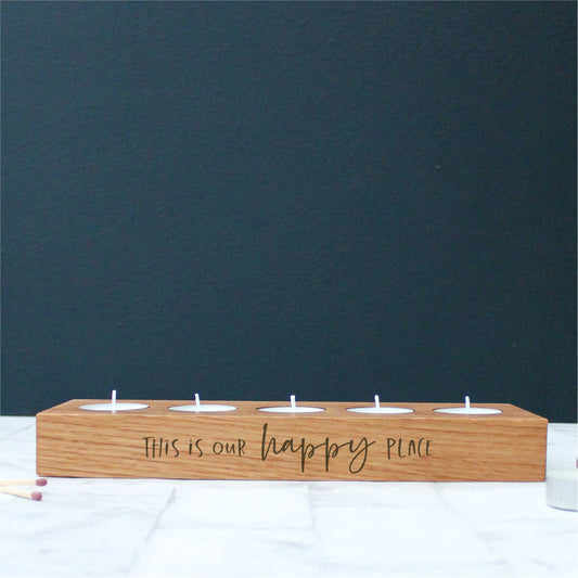 chunky wooden solid oak tealight holder engraved with the phrase this is our happy place on the side