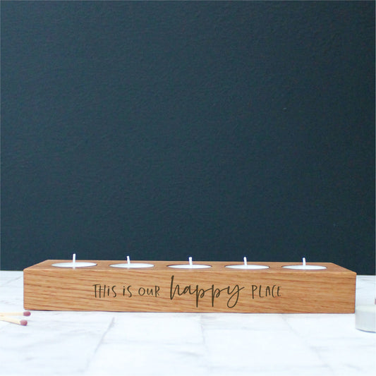 chunky wooden solid oak tealight holder engraved with the phrase this is our happy place on the side