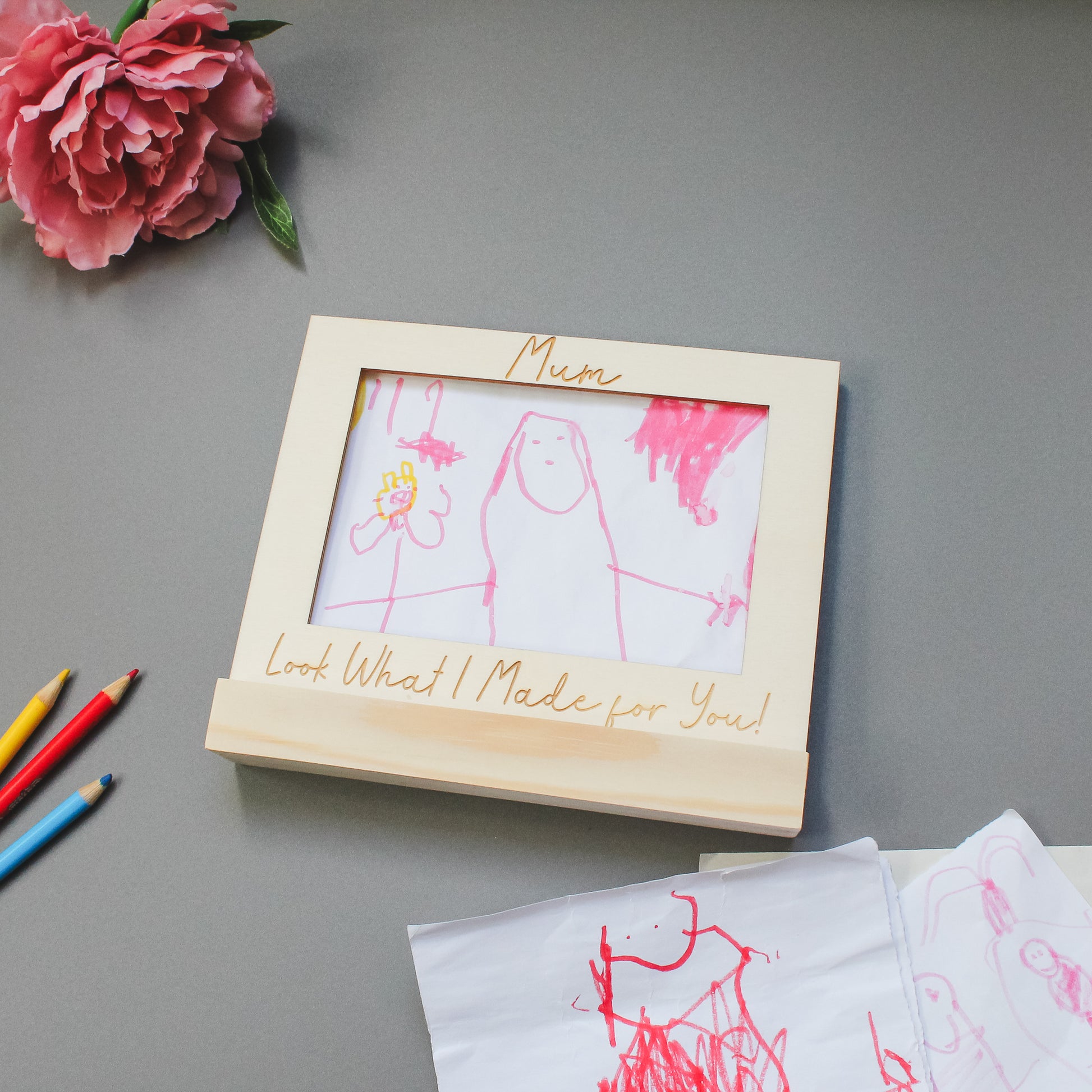 engraved wooden frame with a stand, perfect for displaying kids’ artwork as a keepsake gift for mums or grandparents