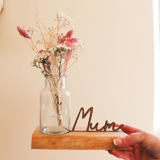 Personalised wooden vase holder made from Scottish elm with a live edge, featuring a 3D name cutout like Mum or Granny – a unique gift for Mother’s Day
