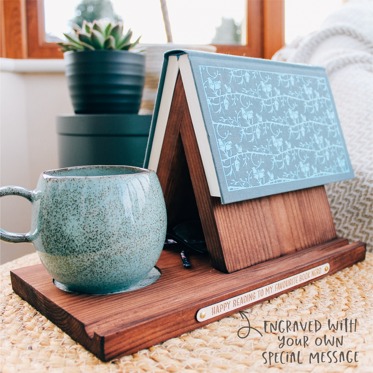 Example of a personalised dark wooden reading nook -book valet in use, holding an open book and a mug of tea