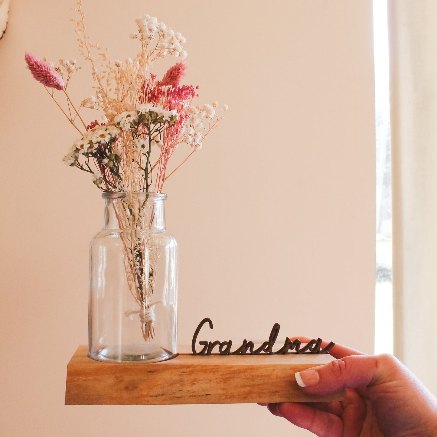 Rustic wooden vase holder with a personalised name display – a sentimental gift perfect for showcasing wildflowers or found treasures from children.