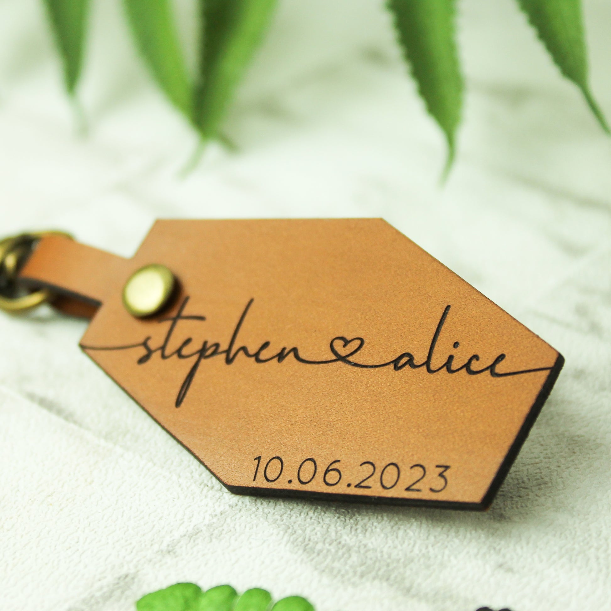 brown leather keyring engraved with couple names and date perfect for anniversary