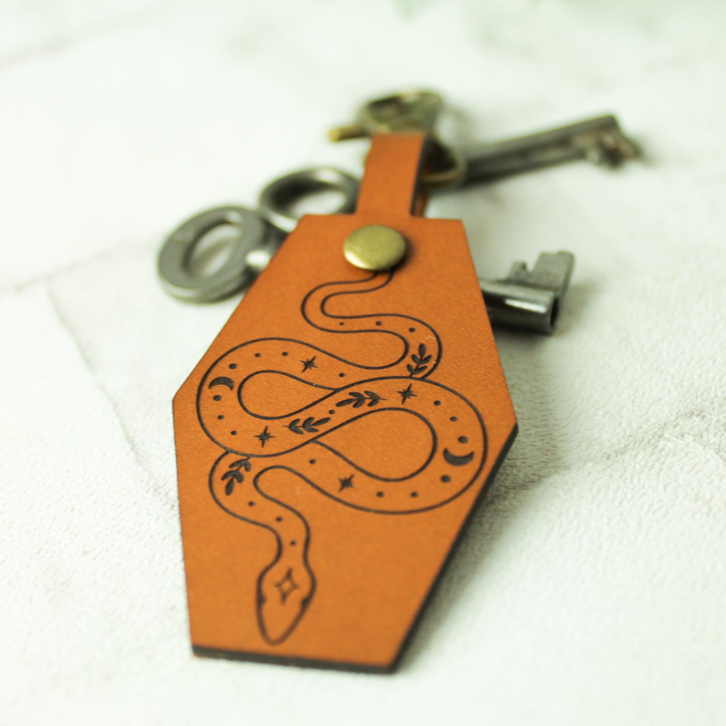 real leather snake keyring with stars and botanical design