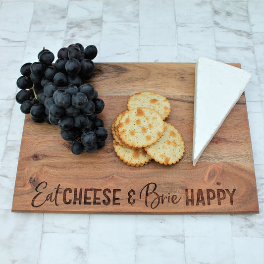 Wooden engraved chopping board with the words eat cheese and brie happy