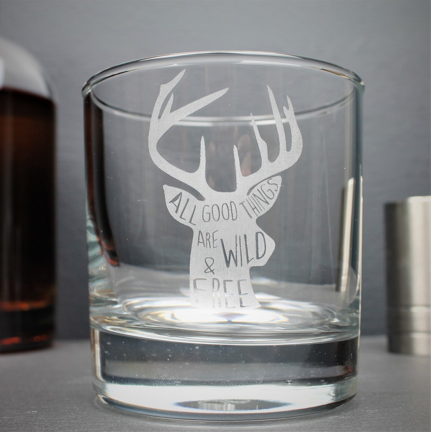 Engraved whisky tumbler glass with stag design and quote