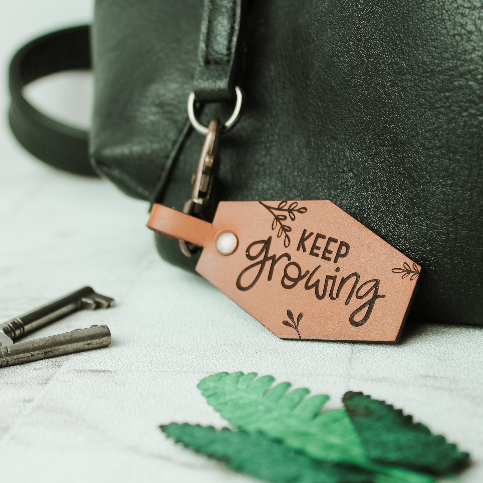 motivational keyring made from real leather keep growing with botanical flourishes