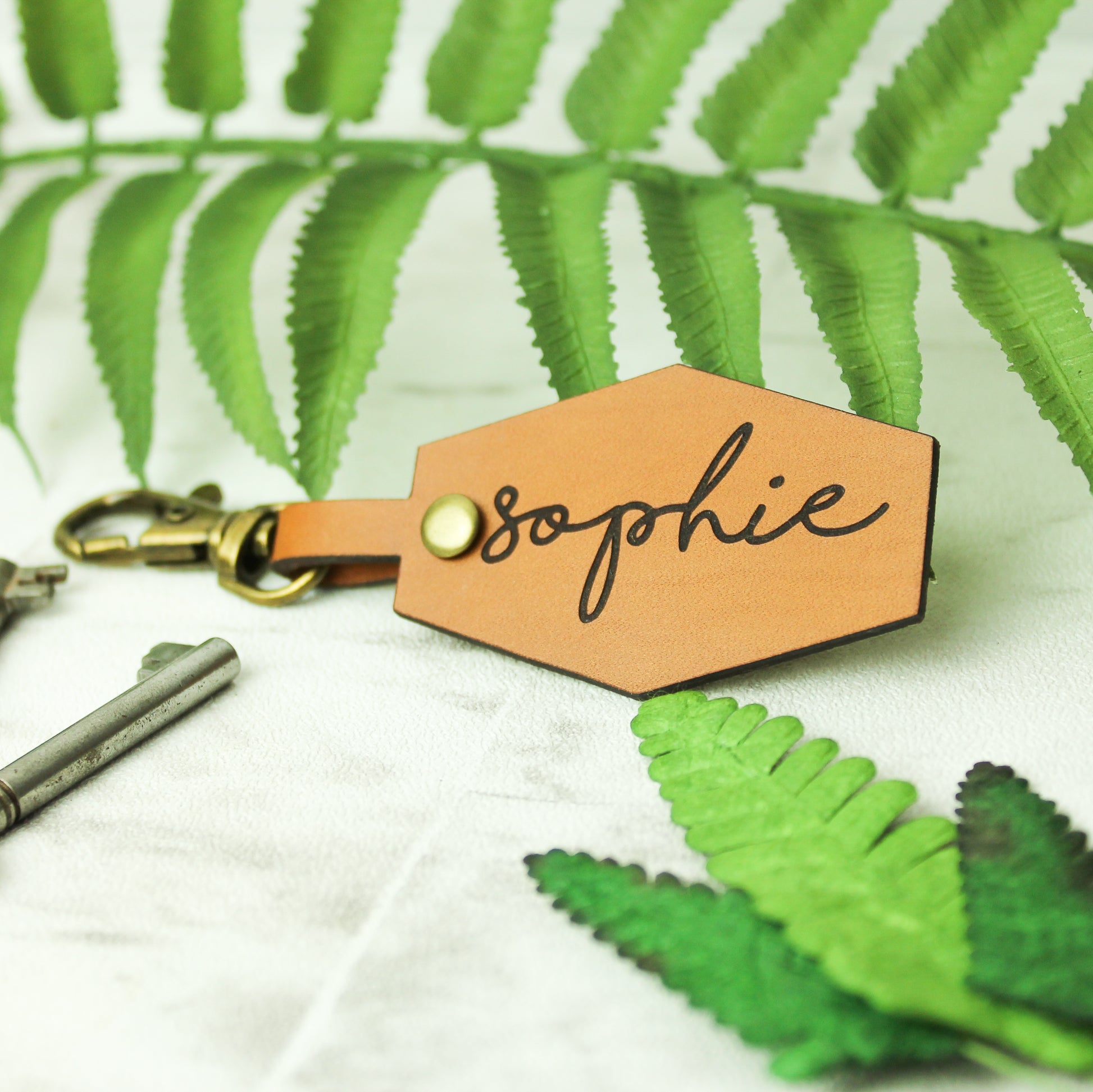 personalised name keyring engraved on a whisky coloured brown leather affixed to a swivel clasp