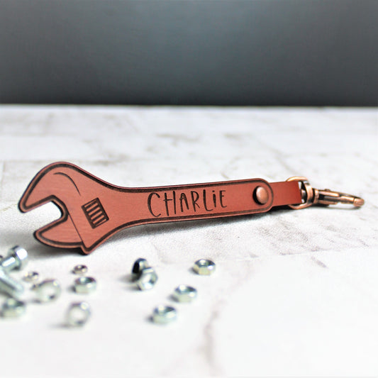 Leather personalised keyring with a name engraved onto it. Made from leather with a copper claps on
