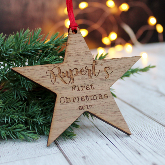 First Christmas for baby, a personalised wooden star bauble engraved with child's name and year. Christmas tree decoration ornament
