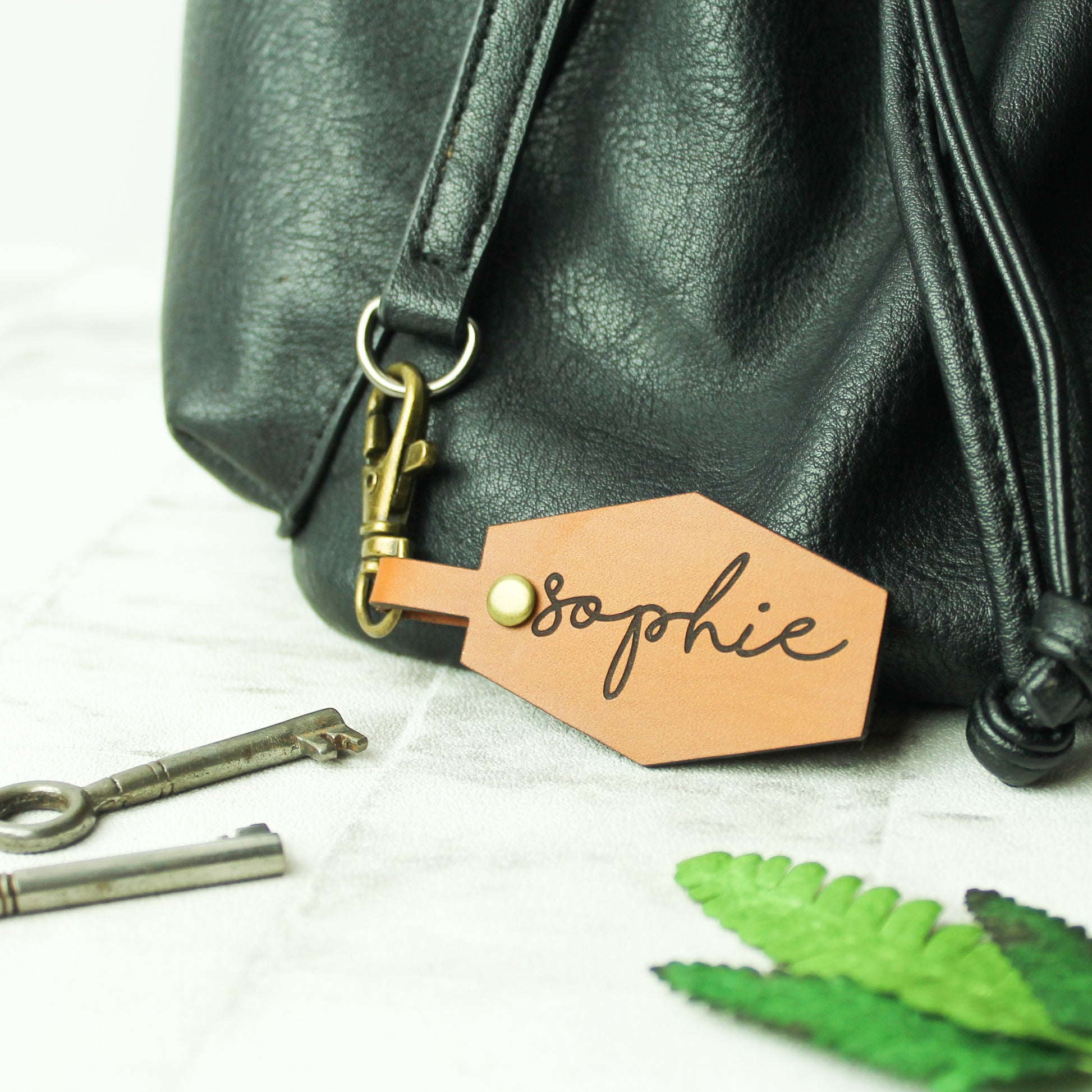 leather bag clasp with personalised name engraved onto it. Made from whisky coloured brown leather and a swivel clasp