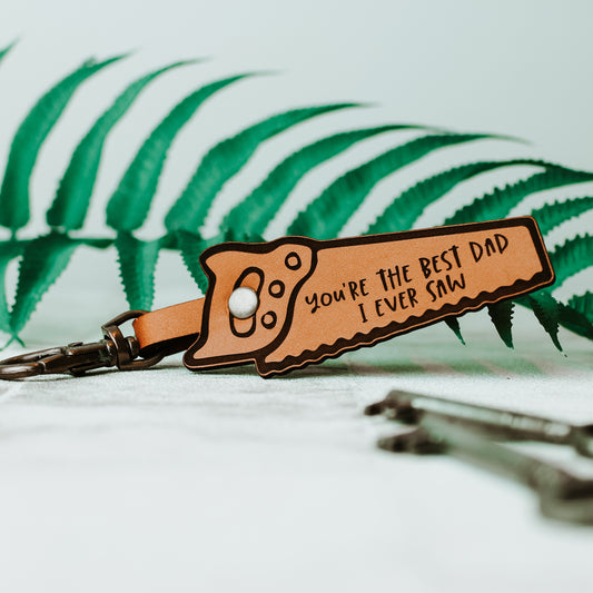 saw shaped tool keyring, engraved with the text, you're the best dad I ever saw, and joined to a swivel keyring