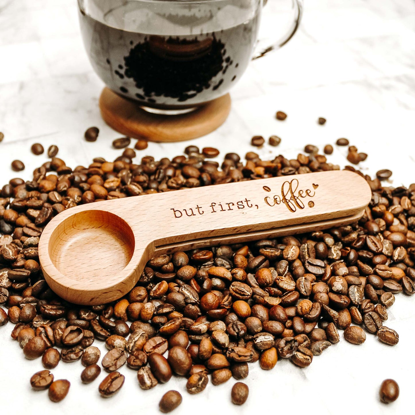 coffee spoon sitting on a bed of coffee beans, perfect gift for the coffee lover