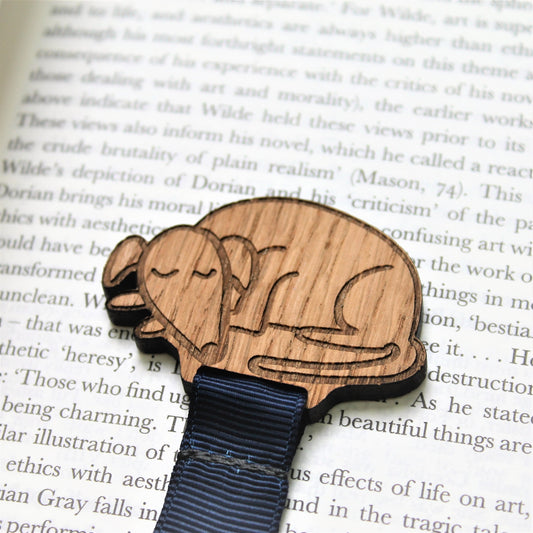 Sleeping dog bookmark on an open book. Ideal dog lover bookmark