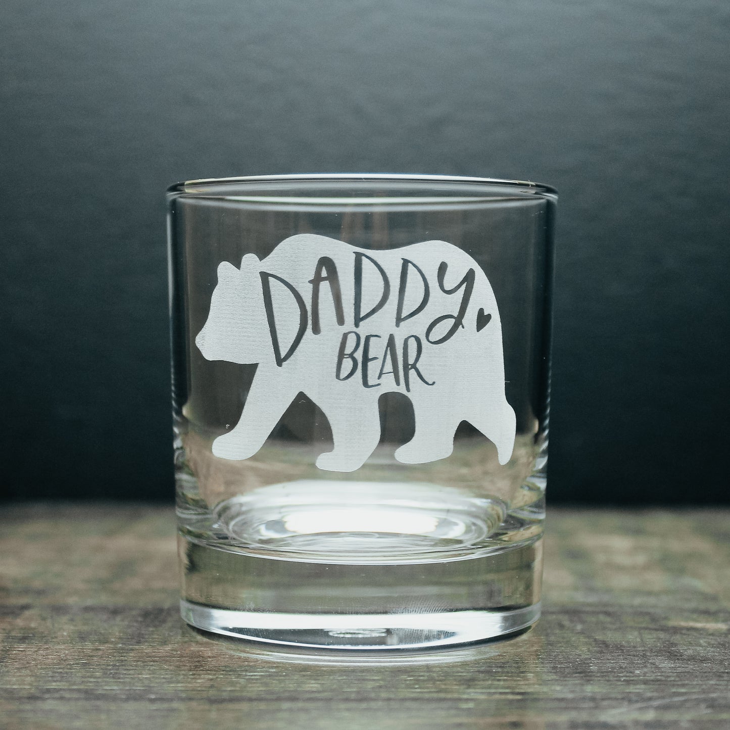 glass tumbler with a white engraved bear on it. Engraved with the wording daddy bear inside of the bear design