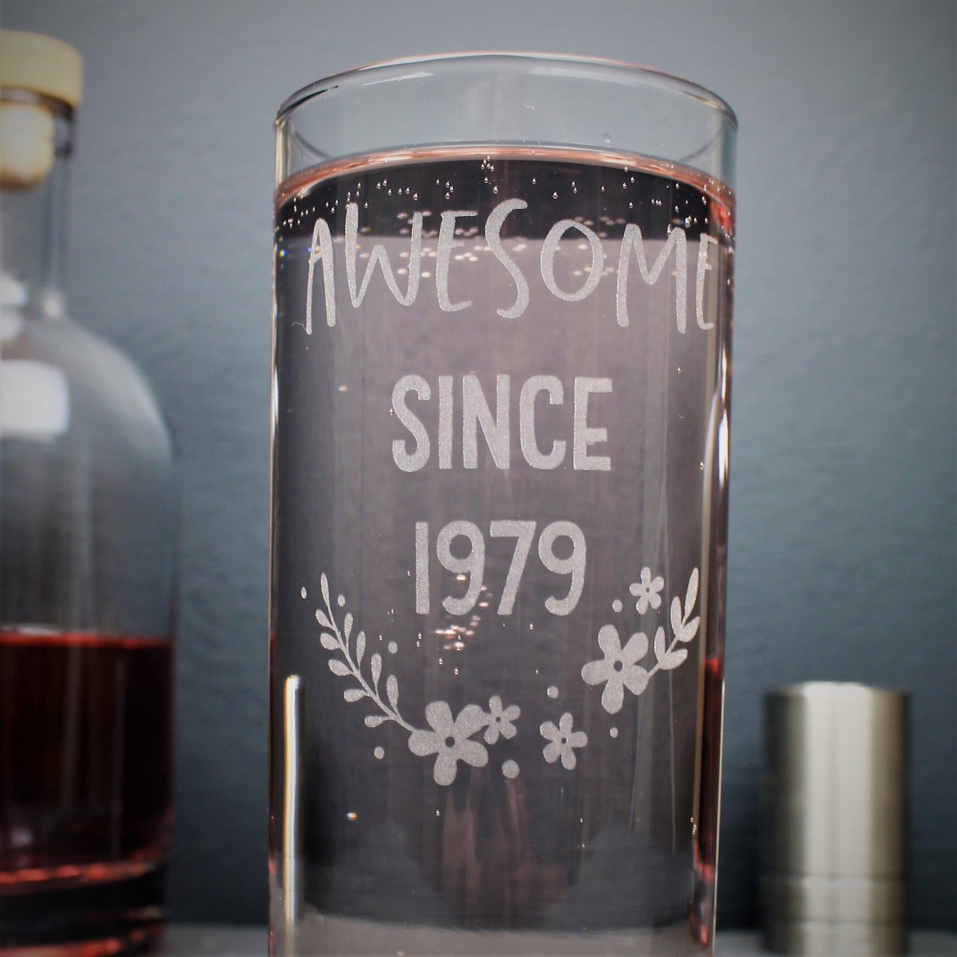 Engraved tall gin glass personalised with birthday year on and flower design