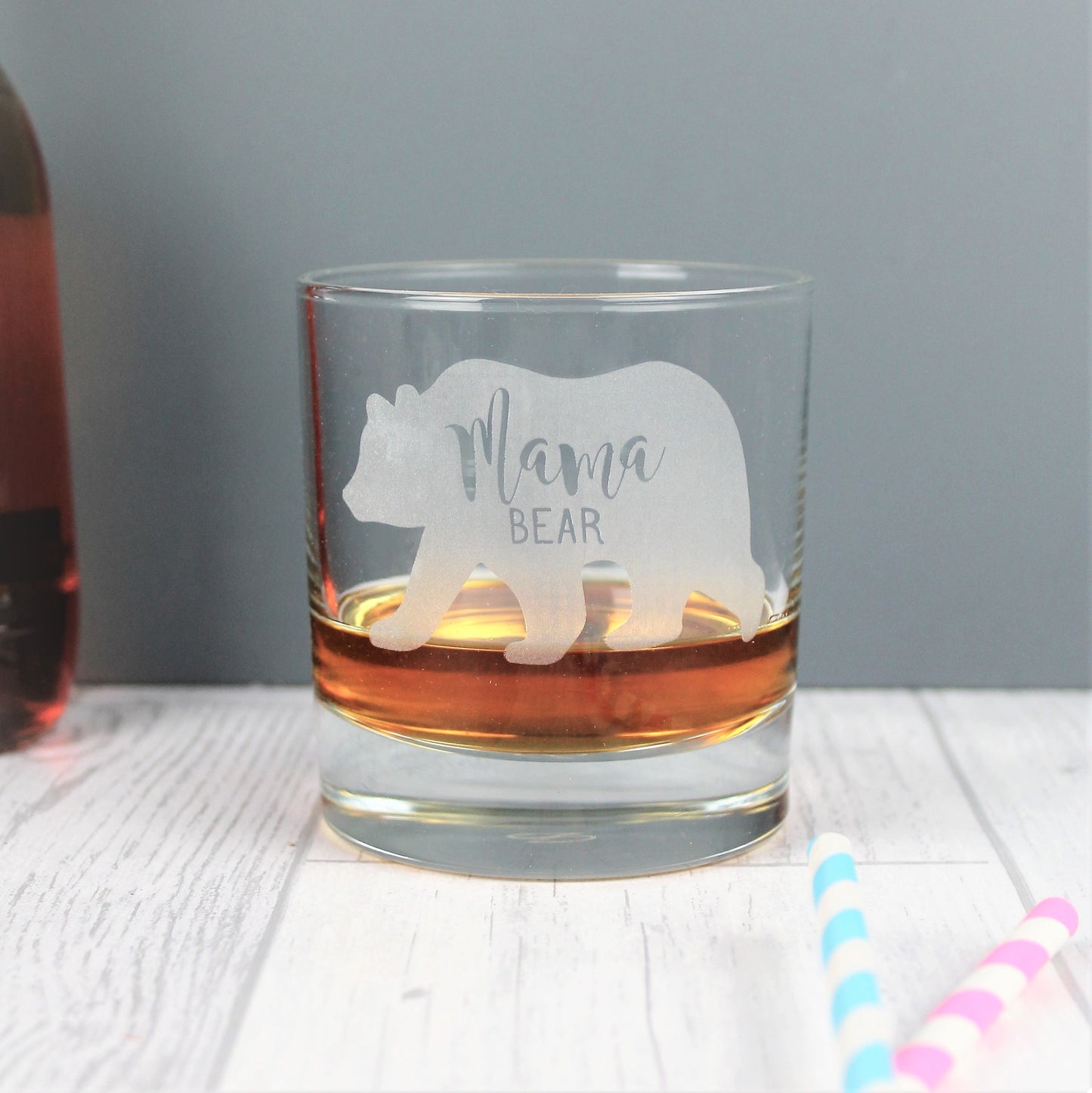 Glass whisky tumbler with the words mama bear engraved into the shape of a bear