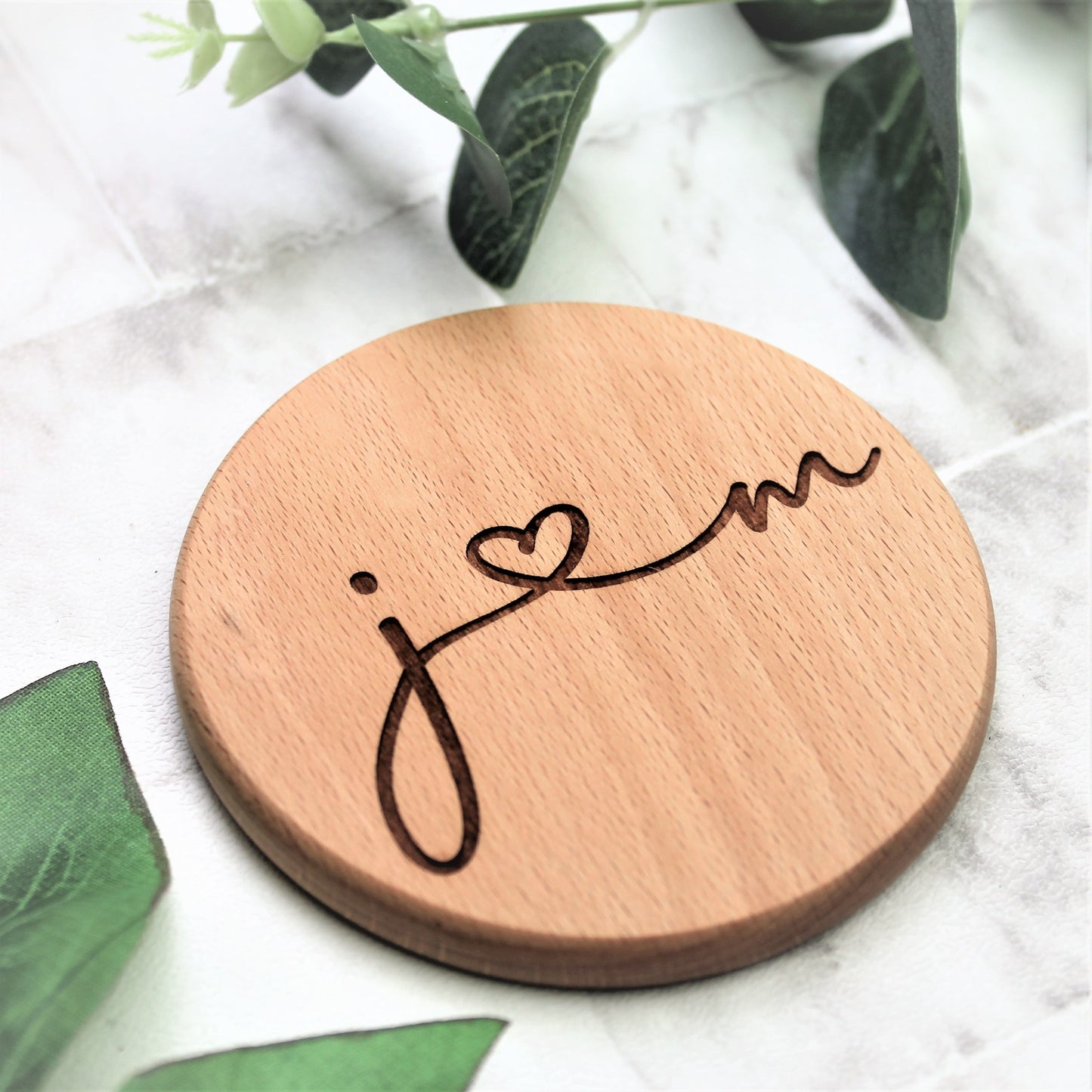 wooden coaster engraved with couples initials