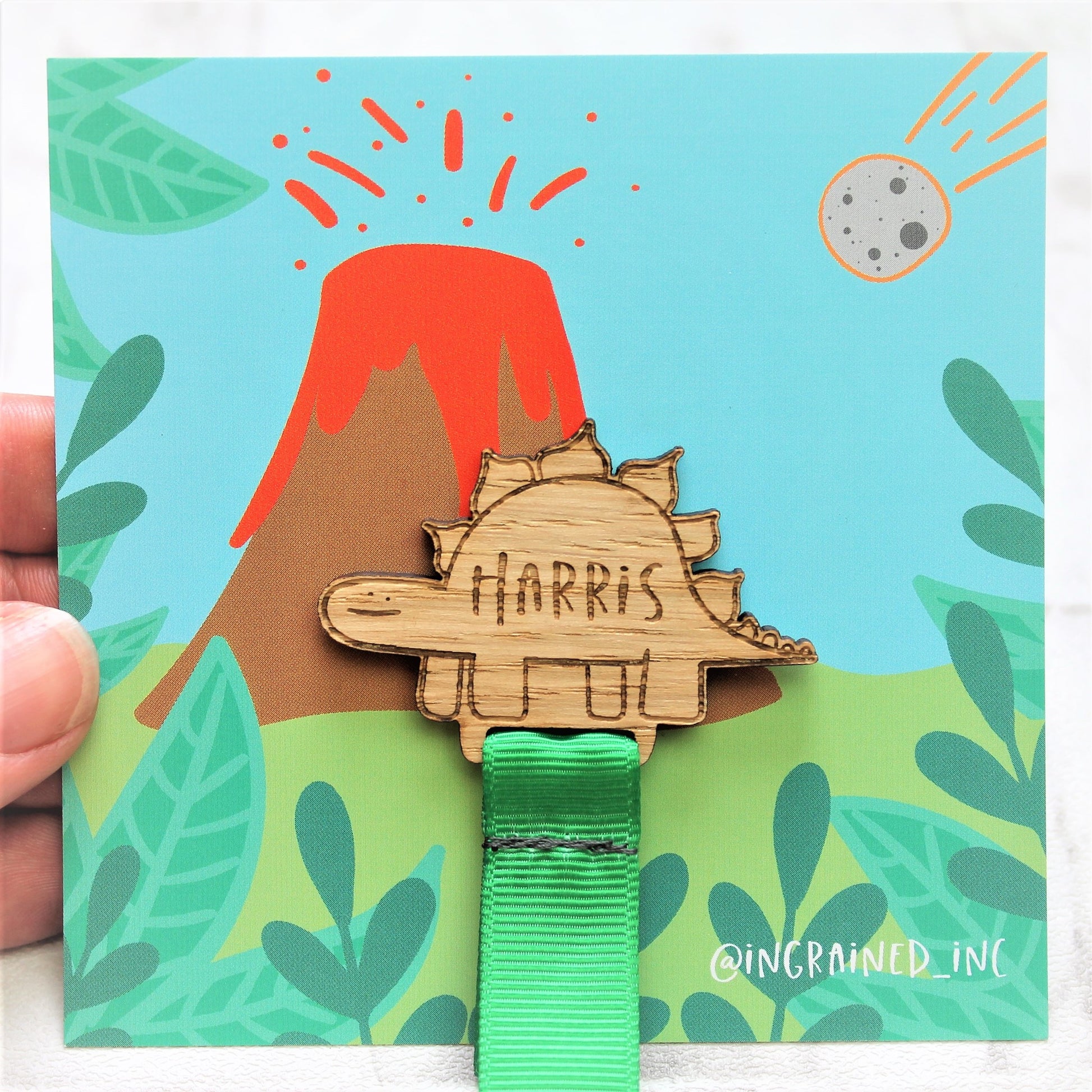 wooden engrave dinosaur bookmark on volcano backing