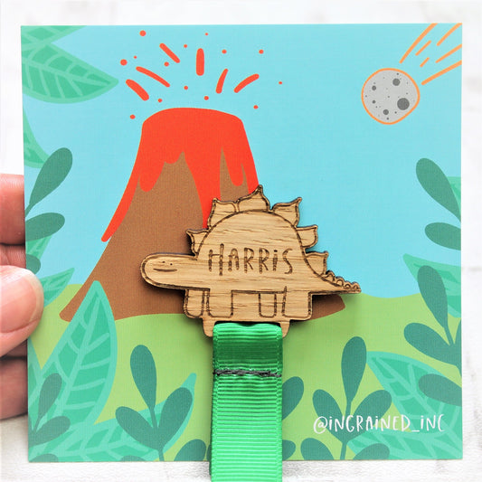 wooden engrave dinosaur bookmark on volcano backing