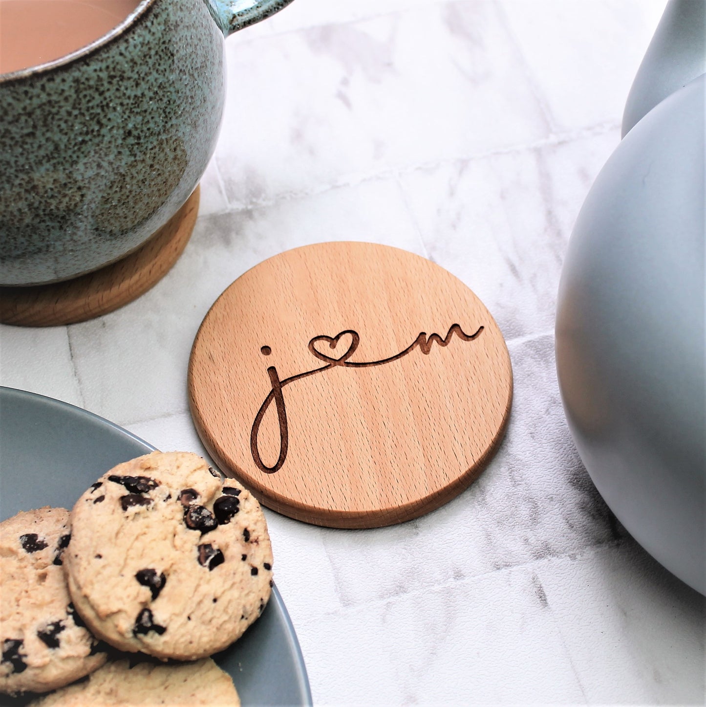 wooden coaster engraved with couples initials  calligraphy hearts