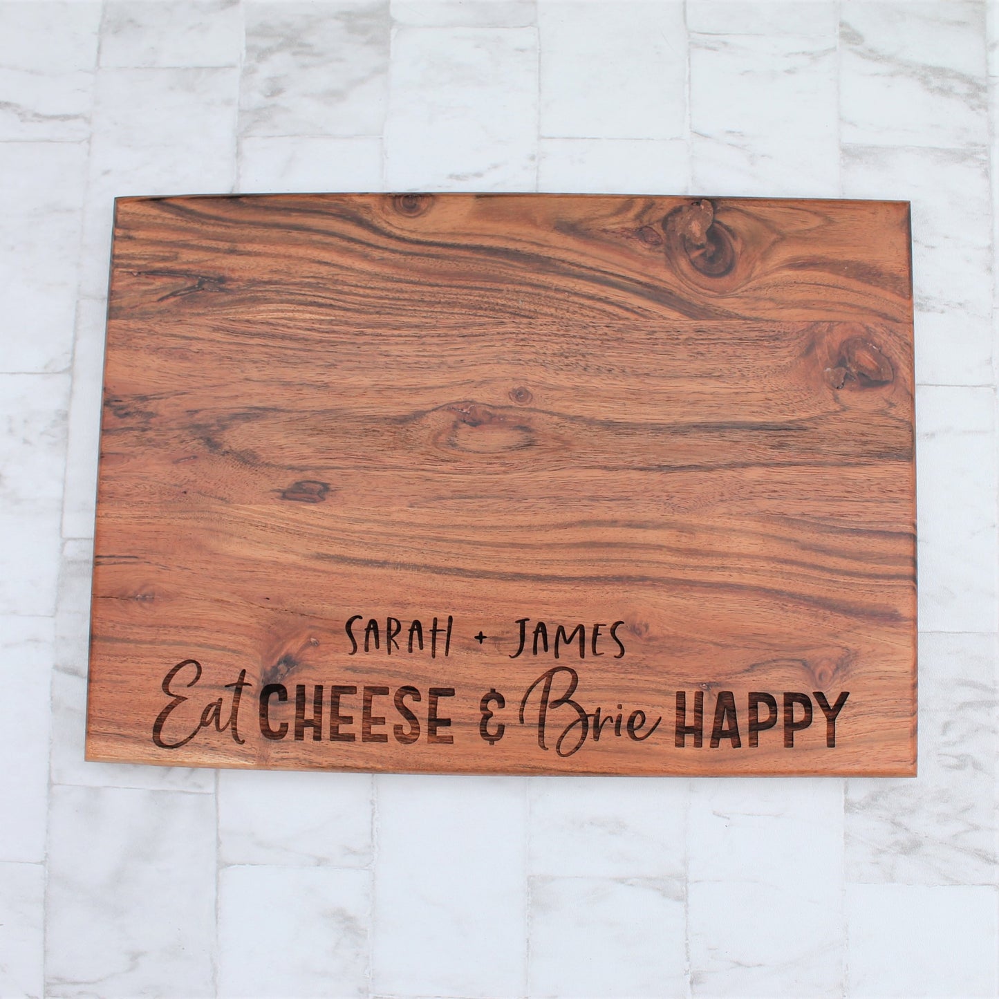 Personalised chopping board for cheese lovers. Engraved with the words eat cheese and brie happy