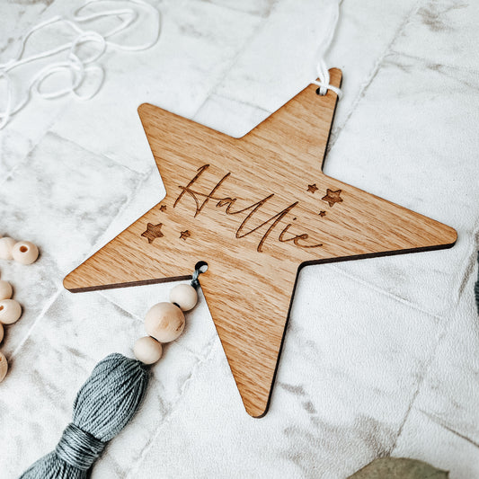 wooden engraved nursery wall star sign. With colourful tassel  & personalised with a name
