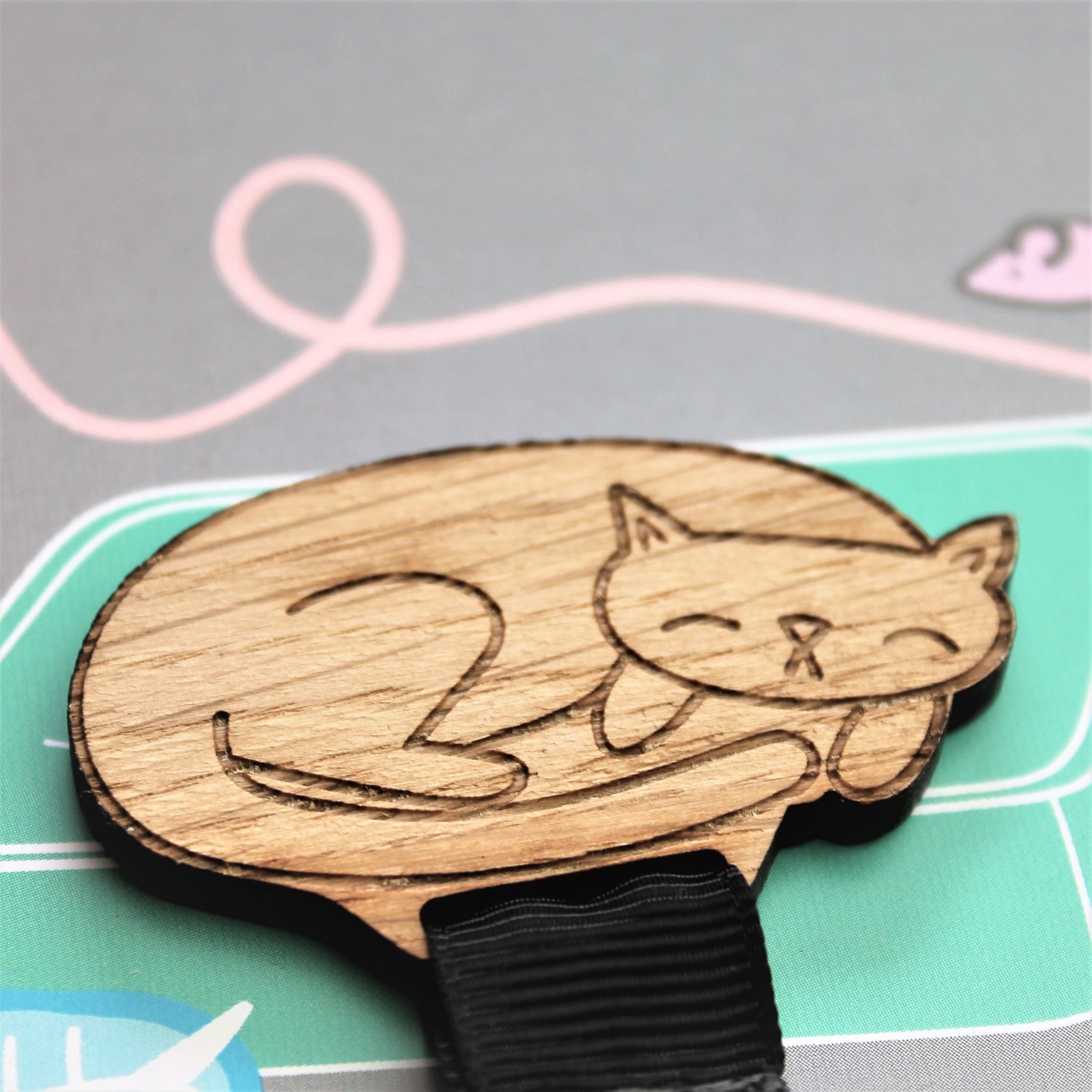 engraved cat bookmark made from wood and ribbon