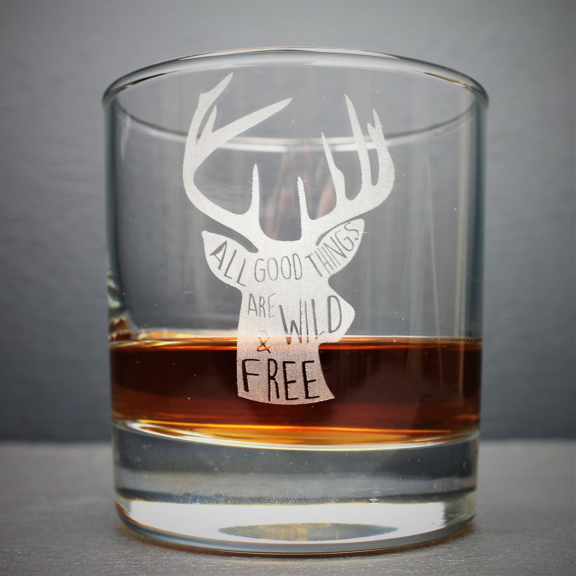 Engraved whisky tumbler glass with stag design and quote