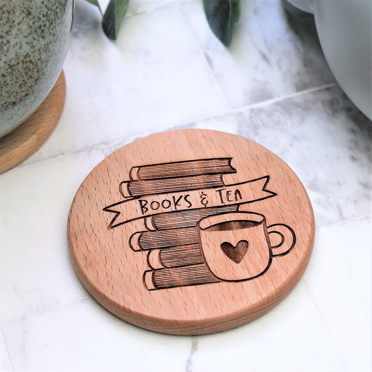 wooden books and tea coaster engraved round