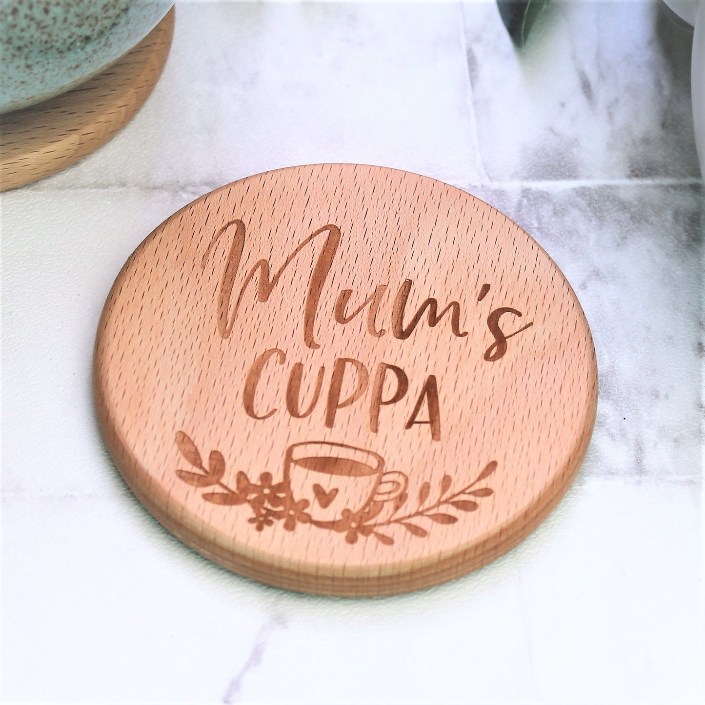 engraved wooden coaster for tea loving mum, engraved with the text mums cuppa with a floral design and tea cup