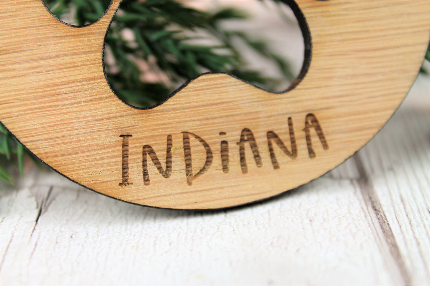 Engraved name close up for wooden pet bauble