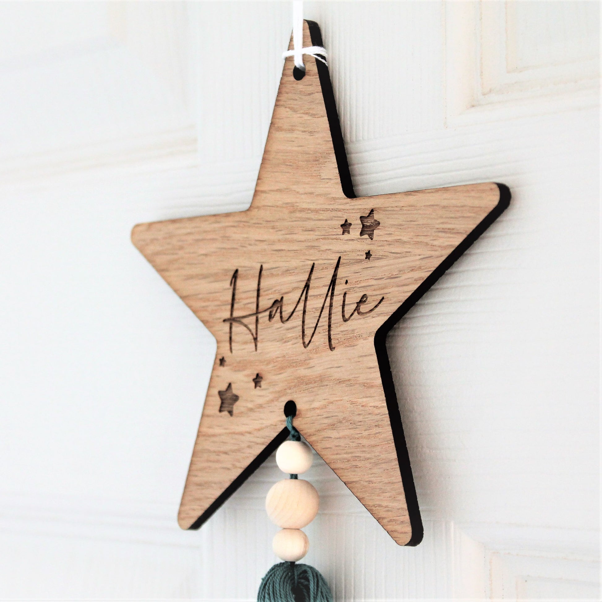 rustic star nursery sign, personalised with a name or word, and adorned with a coloured tassel 