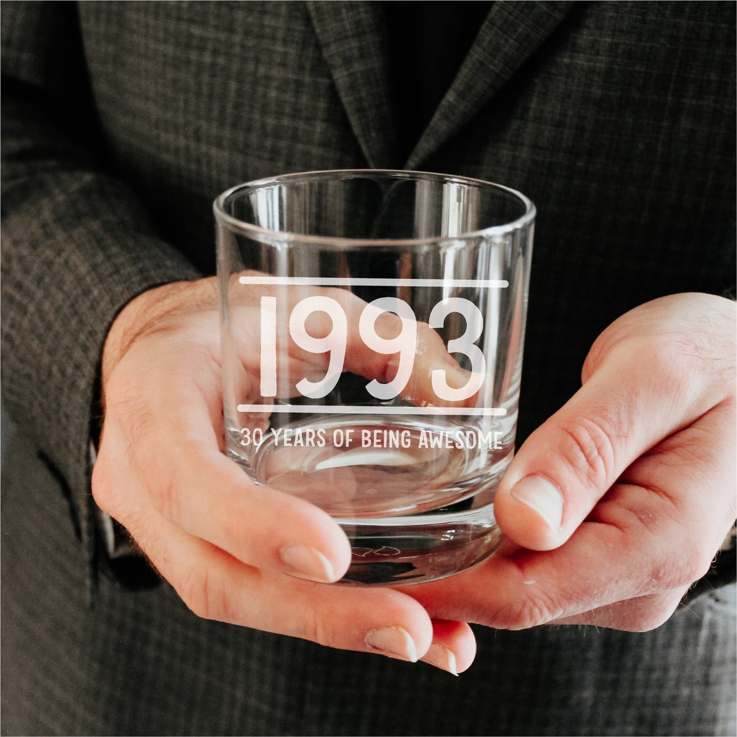 man holding personalised whisky glass tumbler, engraved with the year 1993 and the wording 30 years of being awesome