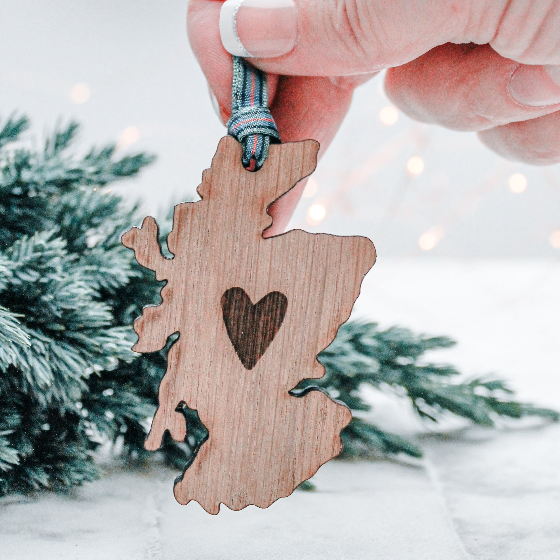 wooden Scotland with engraved heart Christmas decoration with a tartan ribbon
