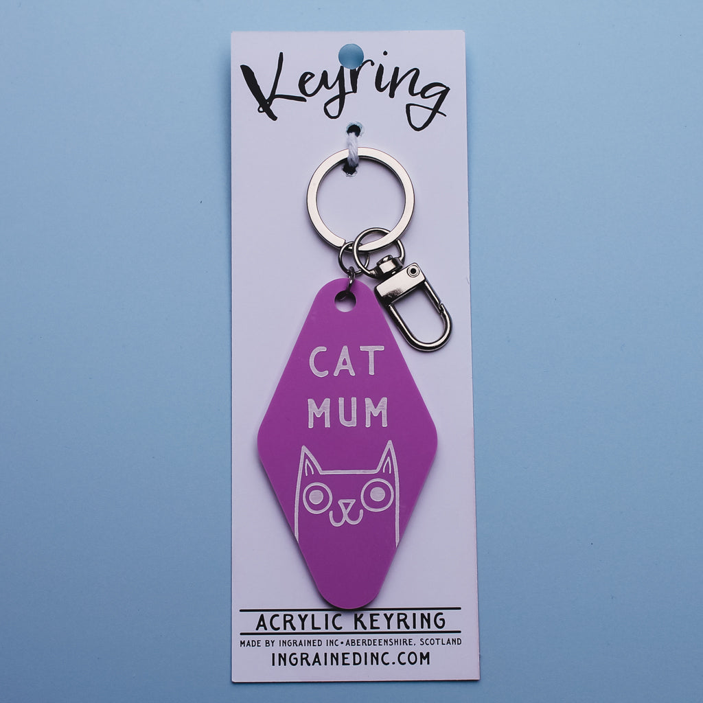 Pink Motel Style keyring with 'Cat Mum' text on a white backing card against a blue background