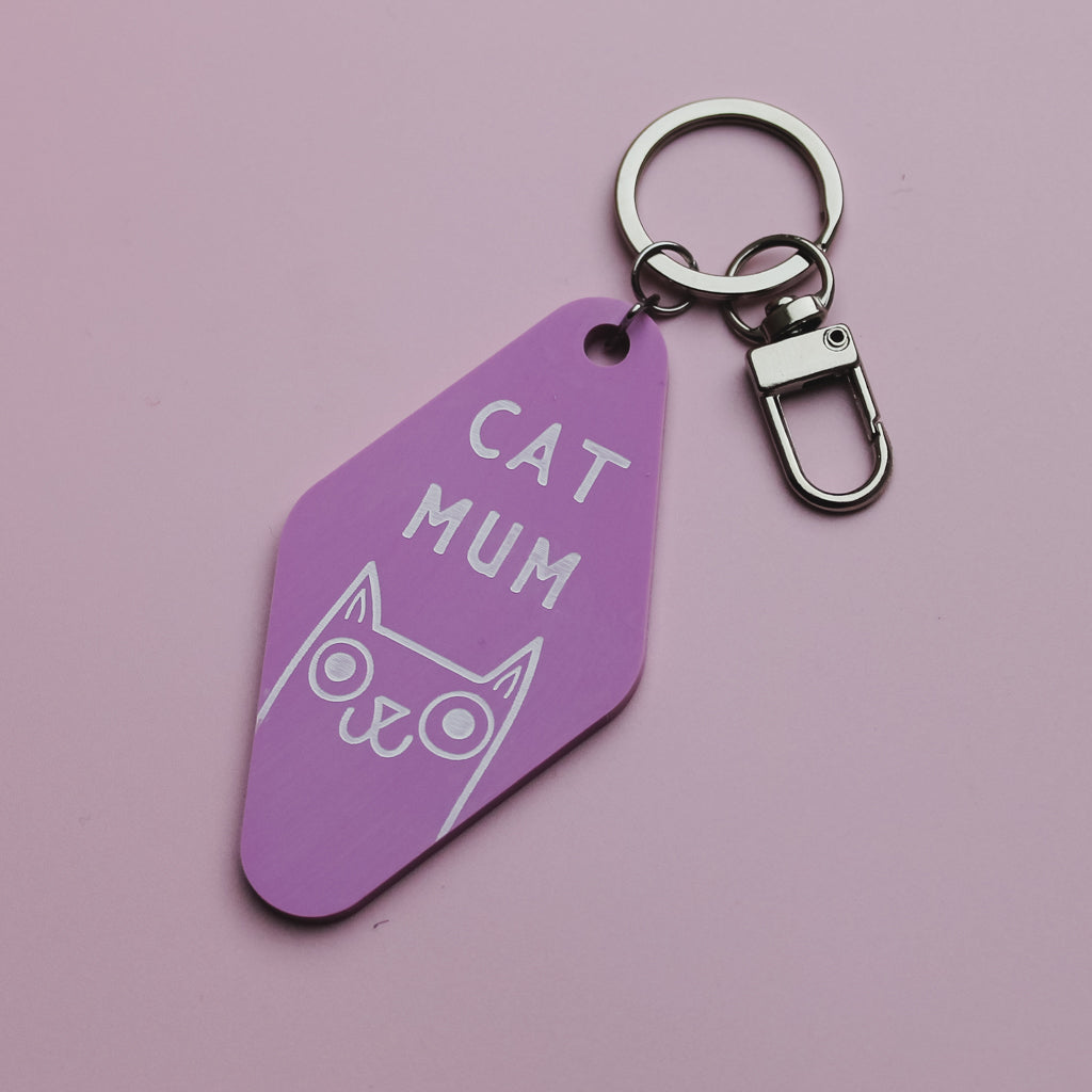 Pink Motel Style keychain with 'CAT MUM' text and cat illustration on a pink background