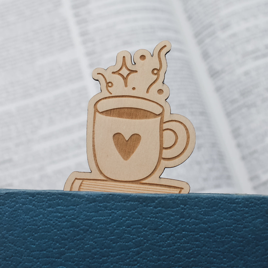 Wooden bookmark shaped like a coffee cup with a heart poking out of the top of a blue book