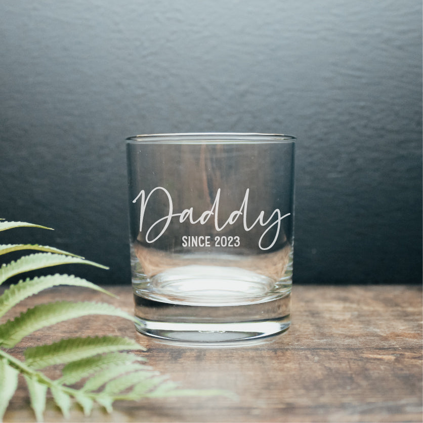 image of a personalised whisky tumbler with the wording, daddy since 2023 engraved on it. 
