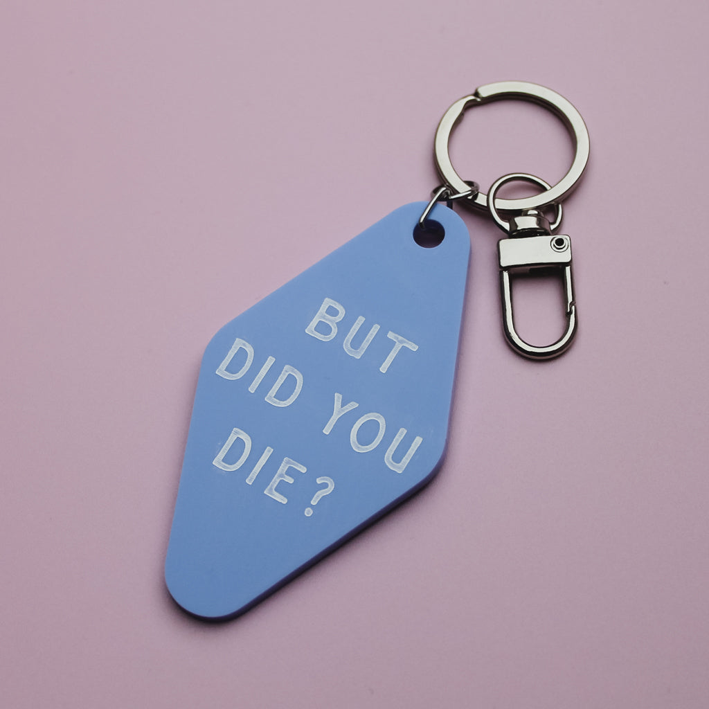 Blue motel style keychain tag with 'BUT DID YOU DIE?' text on a pink background