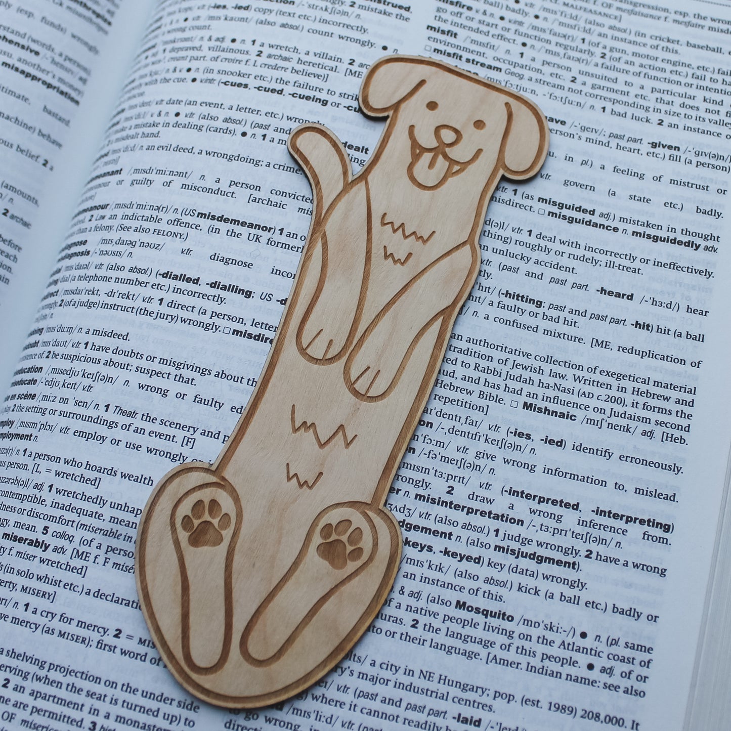 Wooden dog shaped bookmark lying on an open book