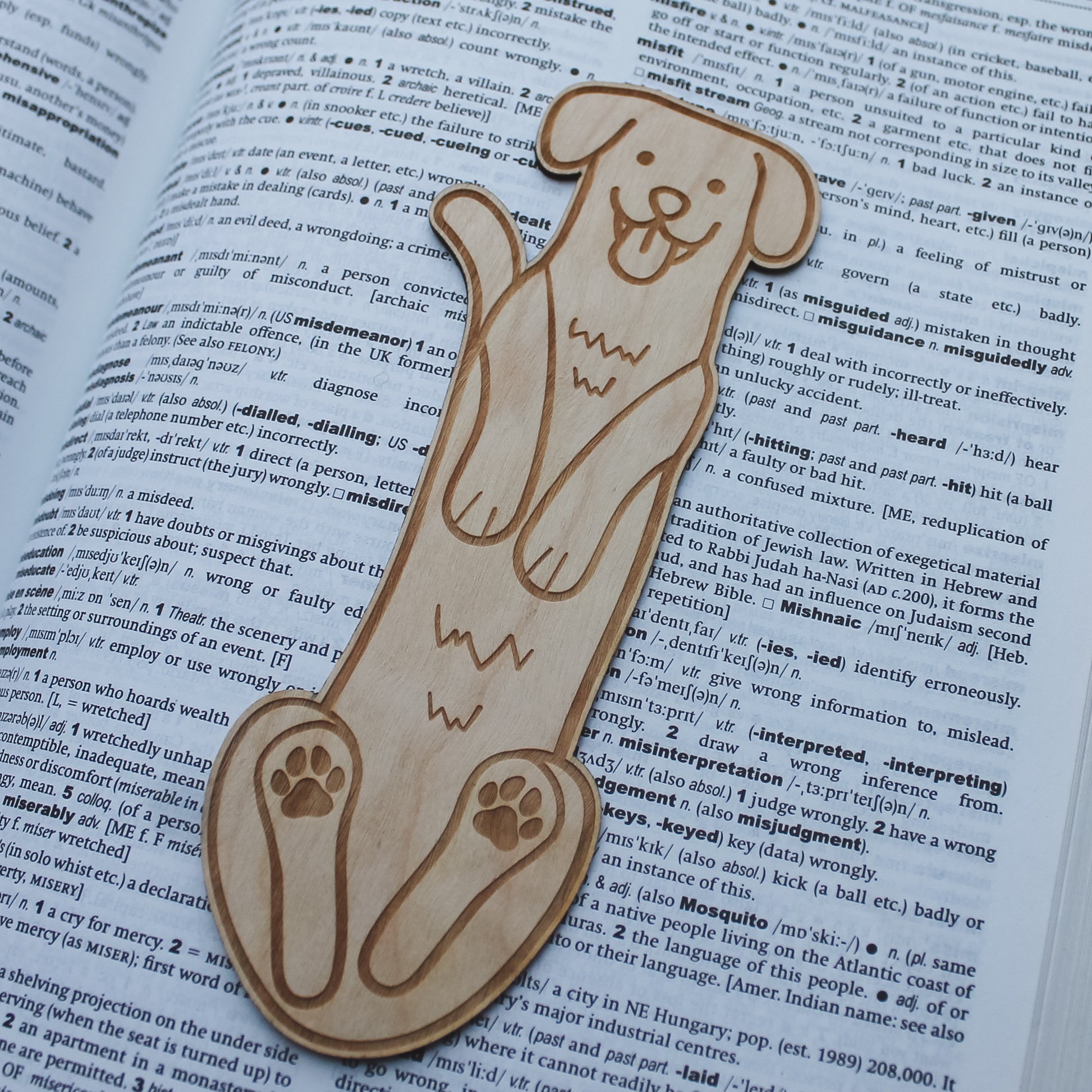 Wooden dog shaped bookmark lying on an open book