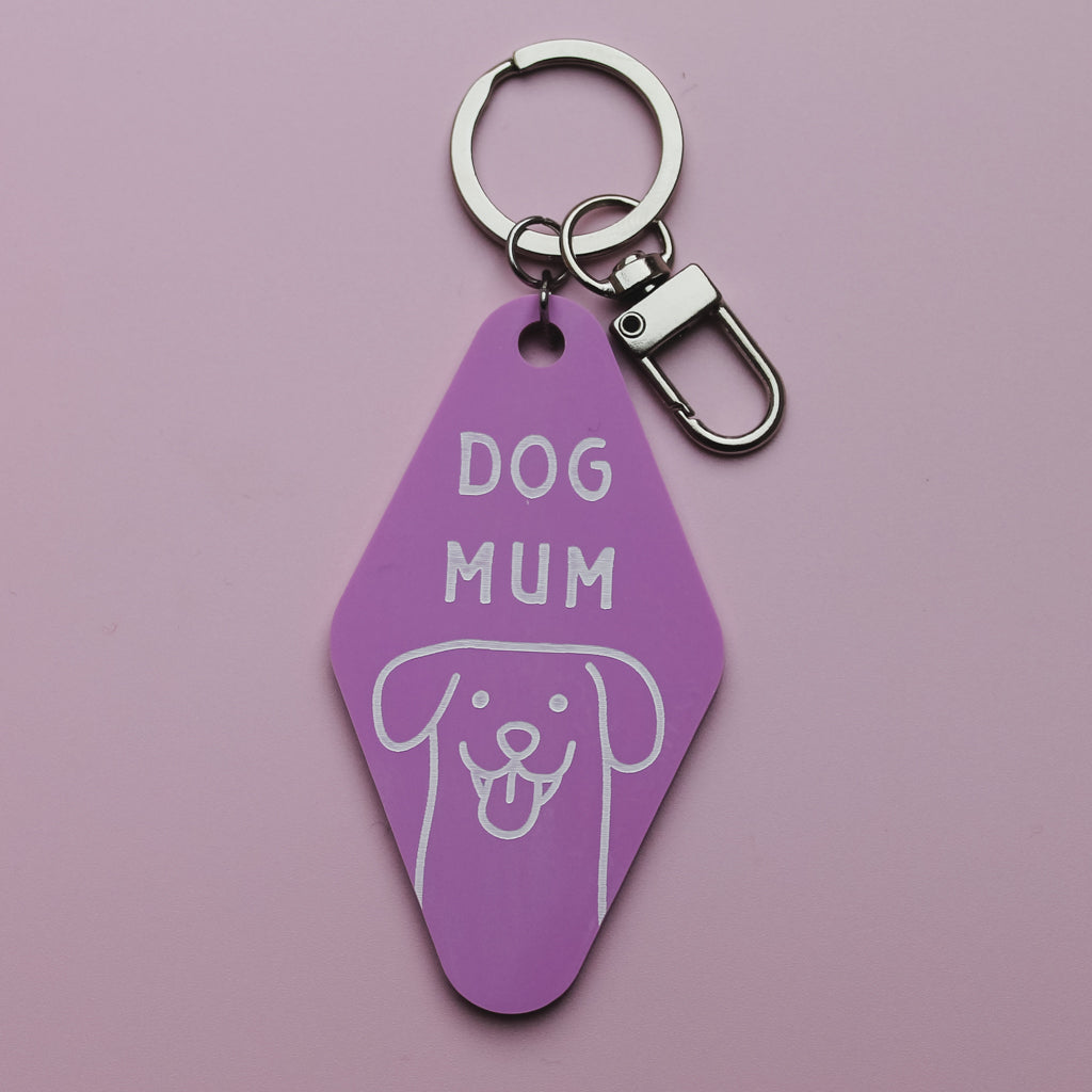 Pink Motel Style keychain tag with 'DOG MUM' text and dog illustration on a pink background
