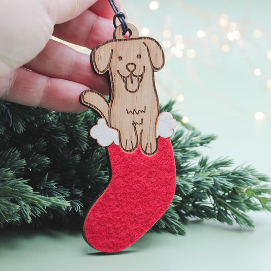 Wooden dog in a Christmas stocking tree decoration, a cute festive ornament and gift for dog lovers.