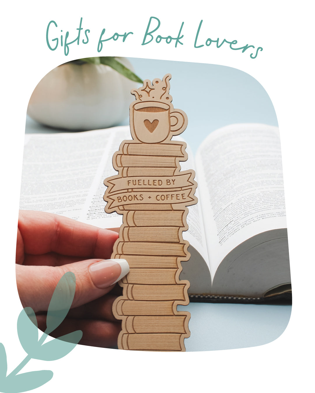 A wooden book bookmark shaped like a stack of books topped with a coffee cup, held by a hand in front of an open book. Teal text at the top reads 'Gifts for Book Lovers'.