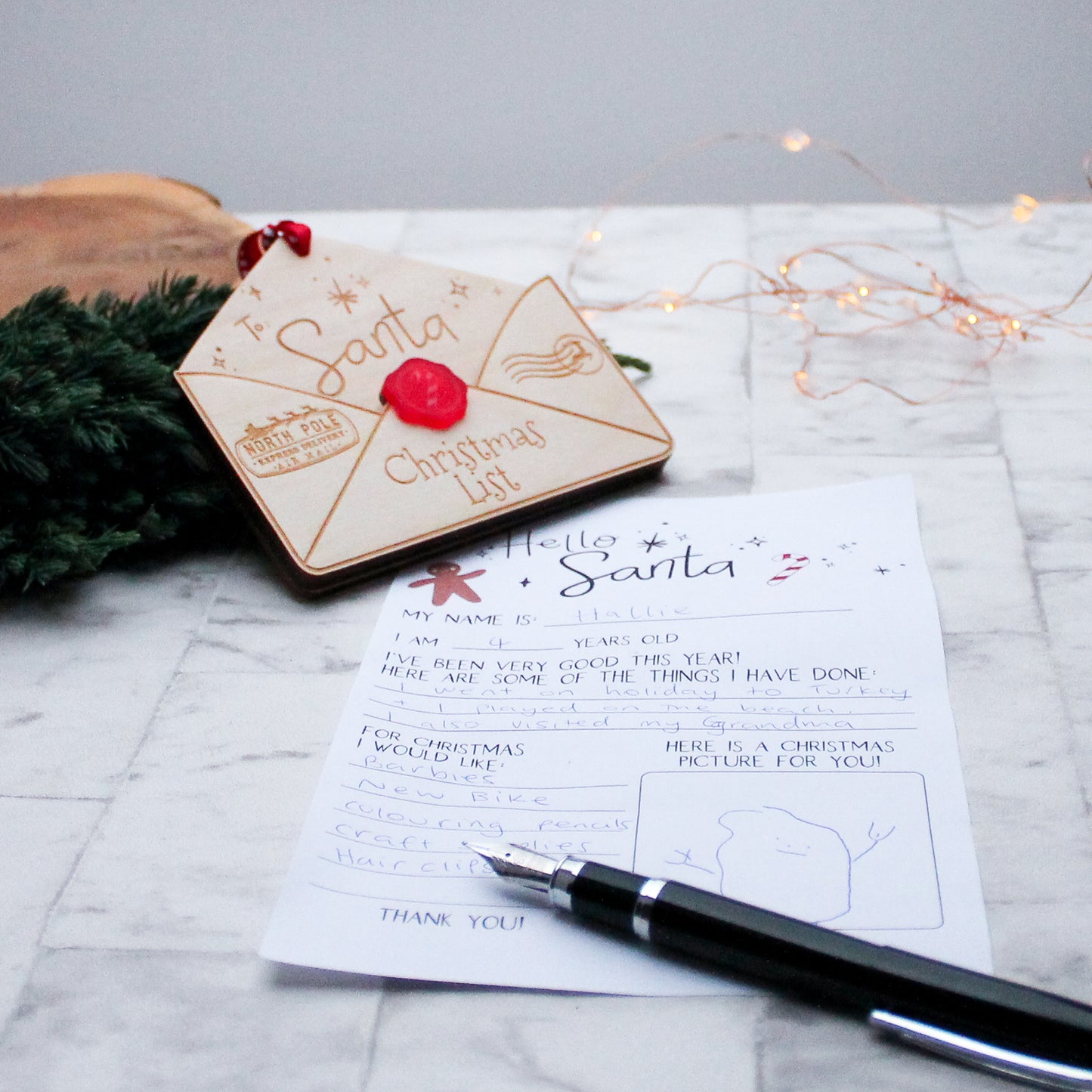wooden envelope that is engraved with the words to santa and Christmas list. It is a envelope to hold your letter to santa and to hang on the christmas tree