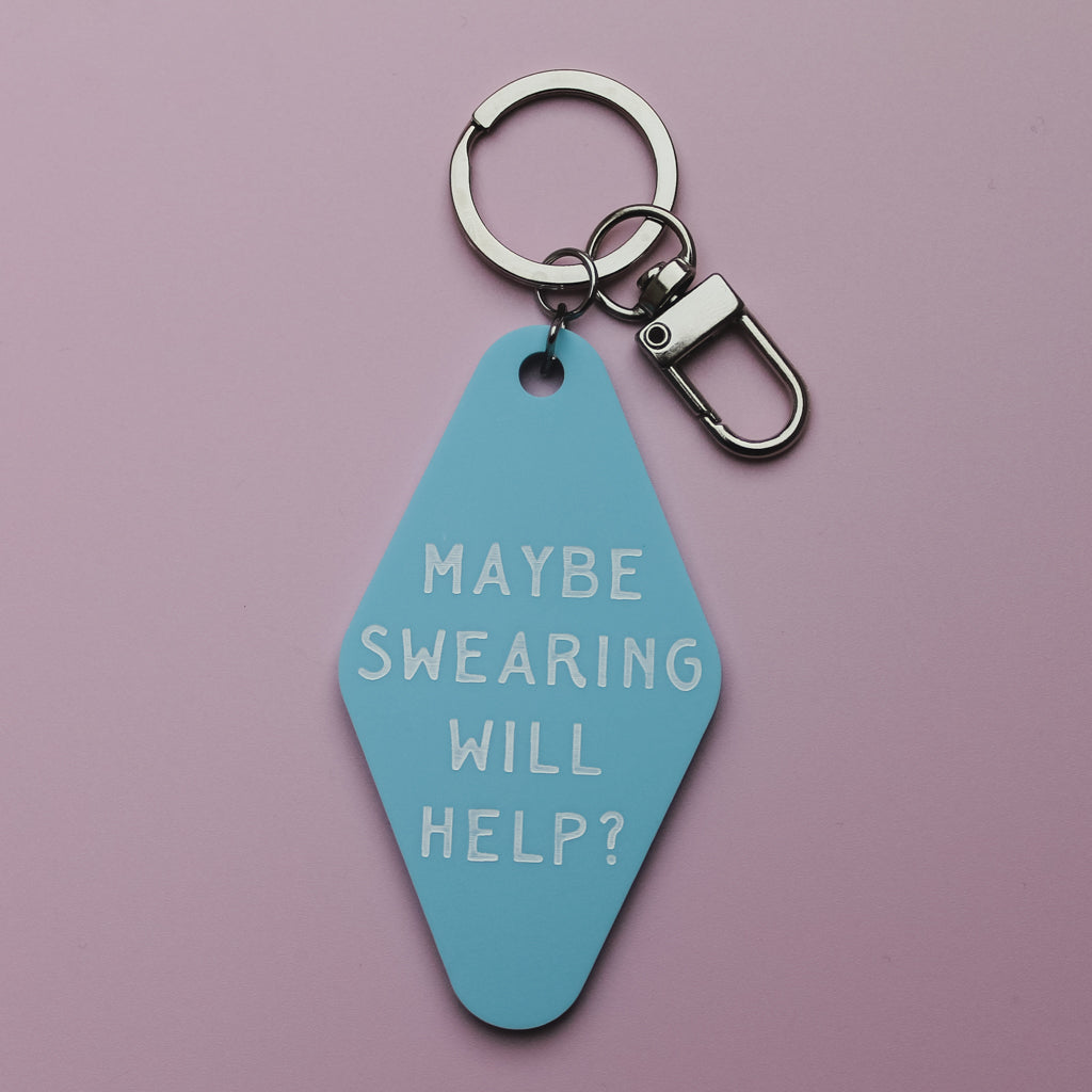 Blue mote style keychain with 'Maybe Swearing Will Help?' text on a pink background